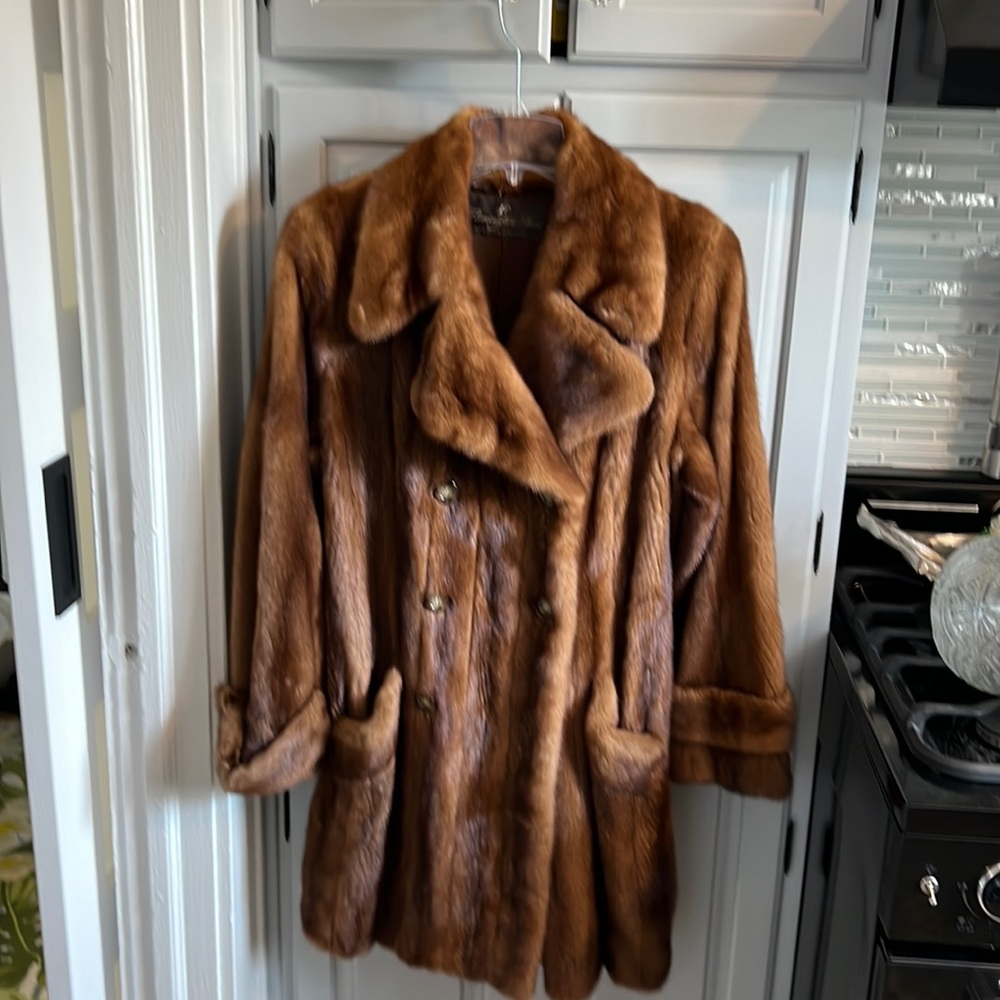 A trench style mink coat     in perfect condition below the knee